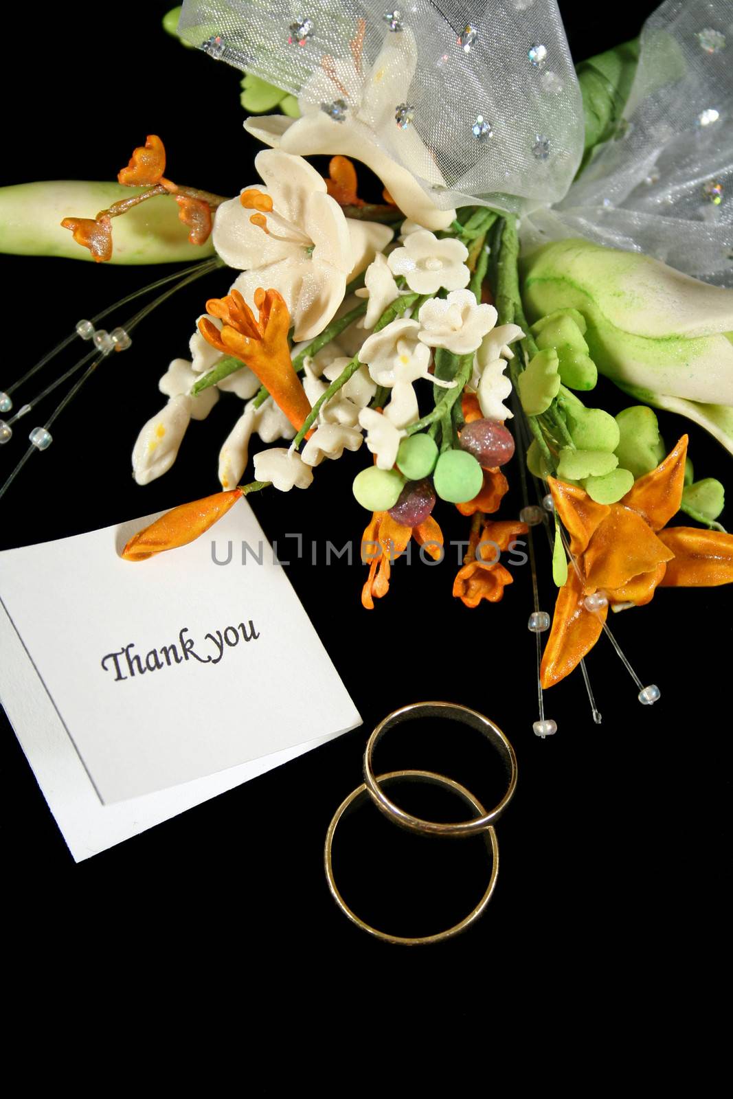 Wedding thank you with rings and bouquet.