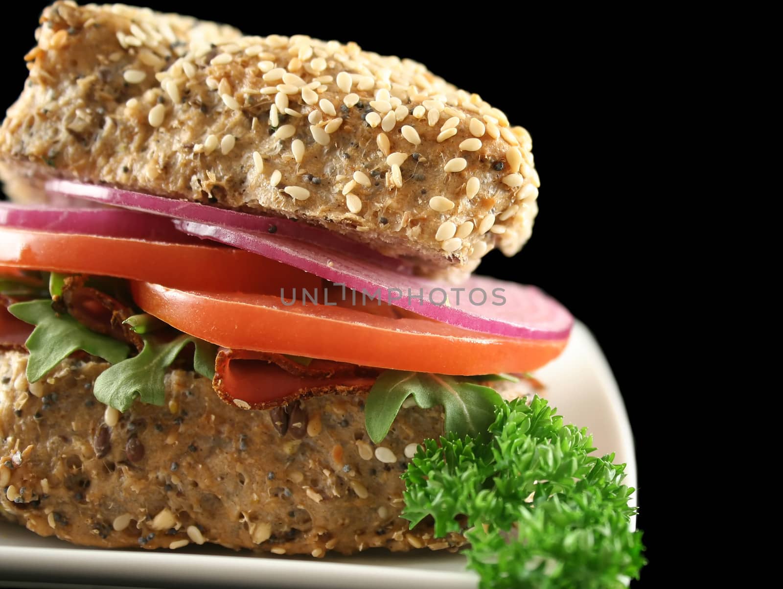 Pastrami and salad wholegrain seeded roll ready to serve.