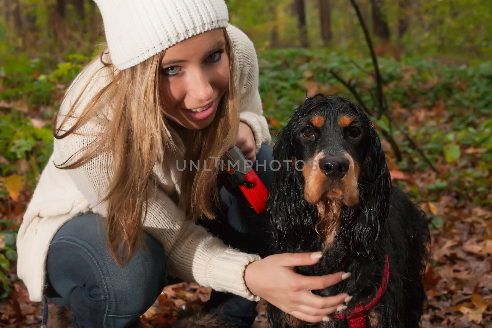 Girl and her dog are having a wet time in the rain