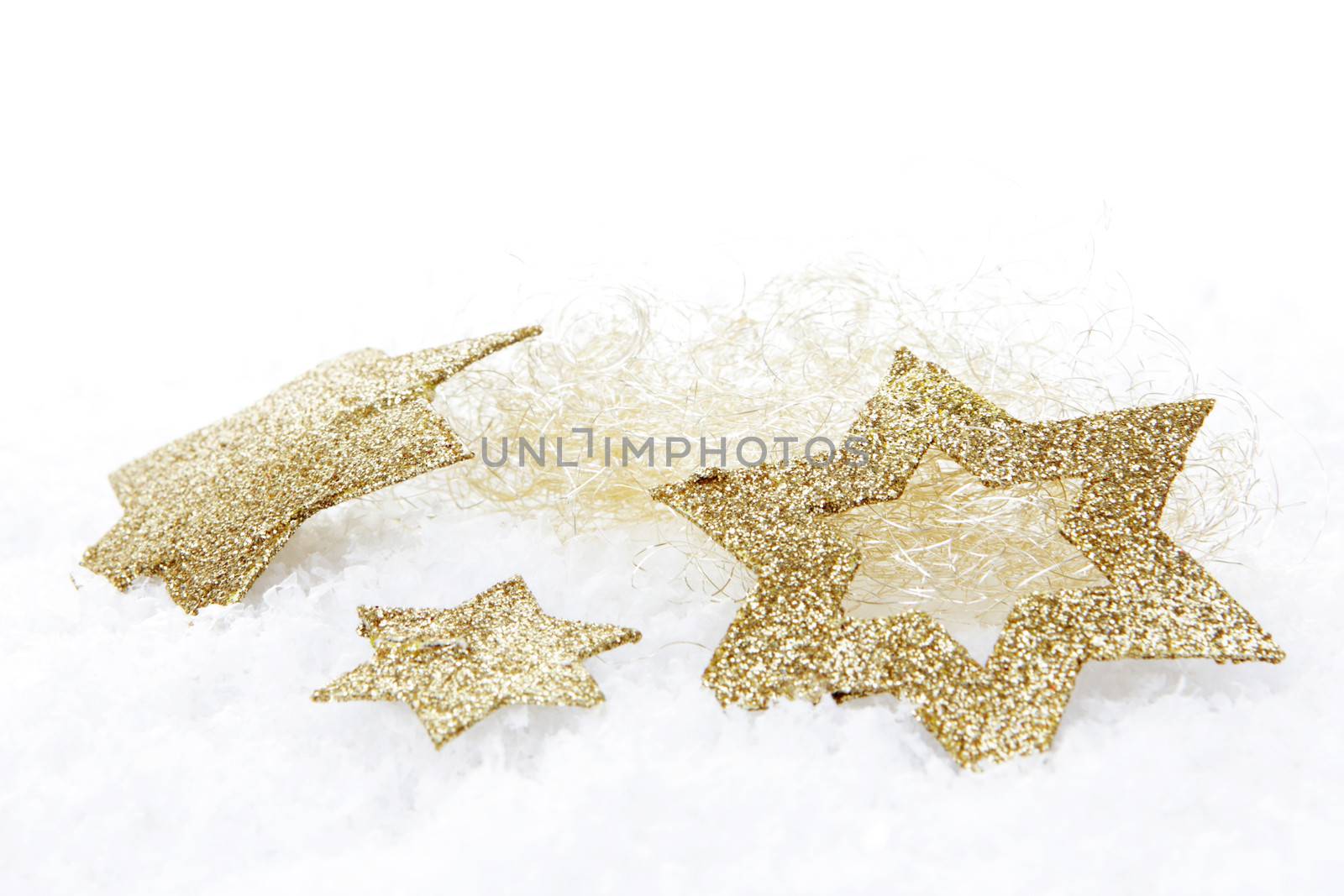 golden christmas stars on snow