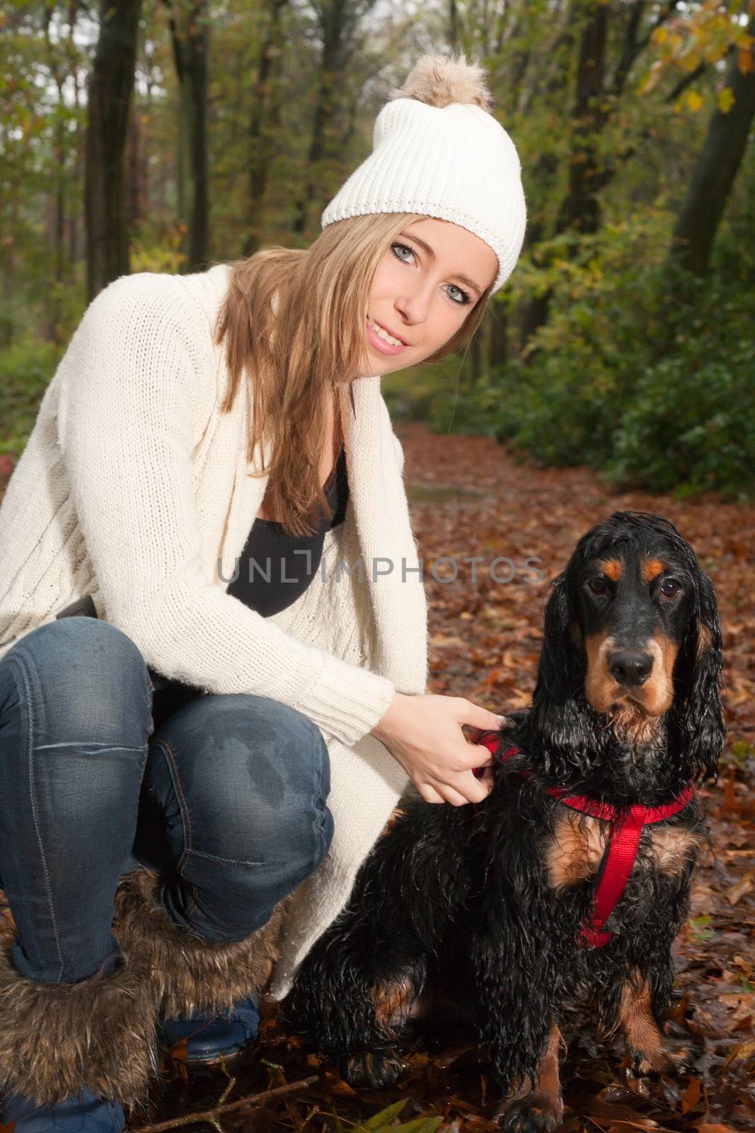 Girl and her dog are having a wet time in the rain