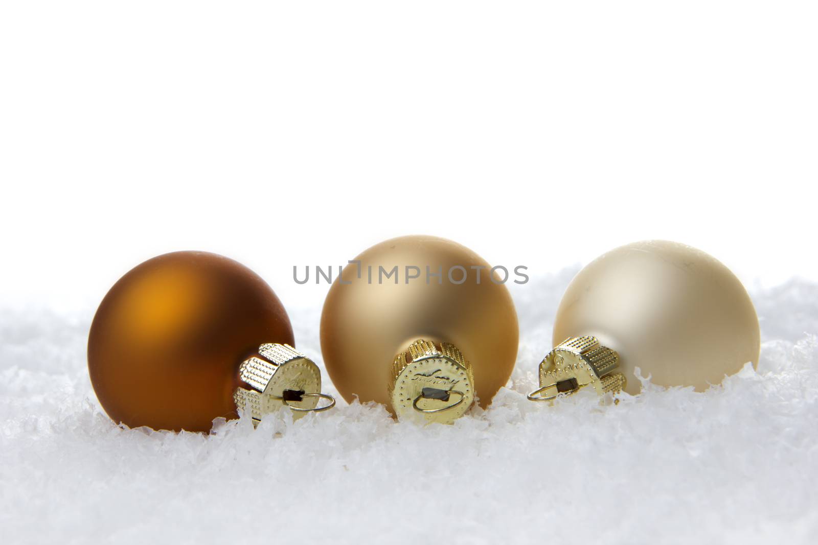 creme christmas balls on snow