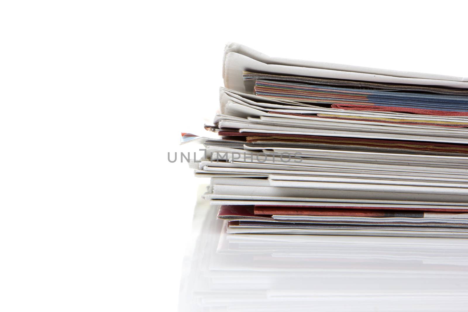 several newspapers, journals stacked on white background