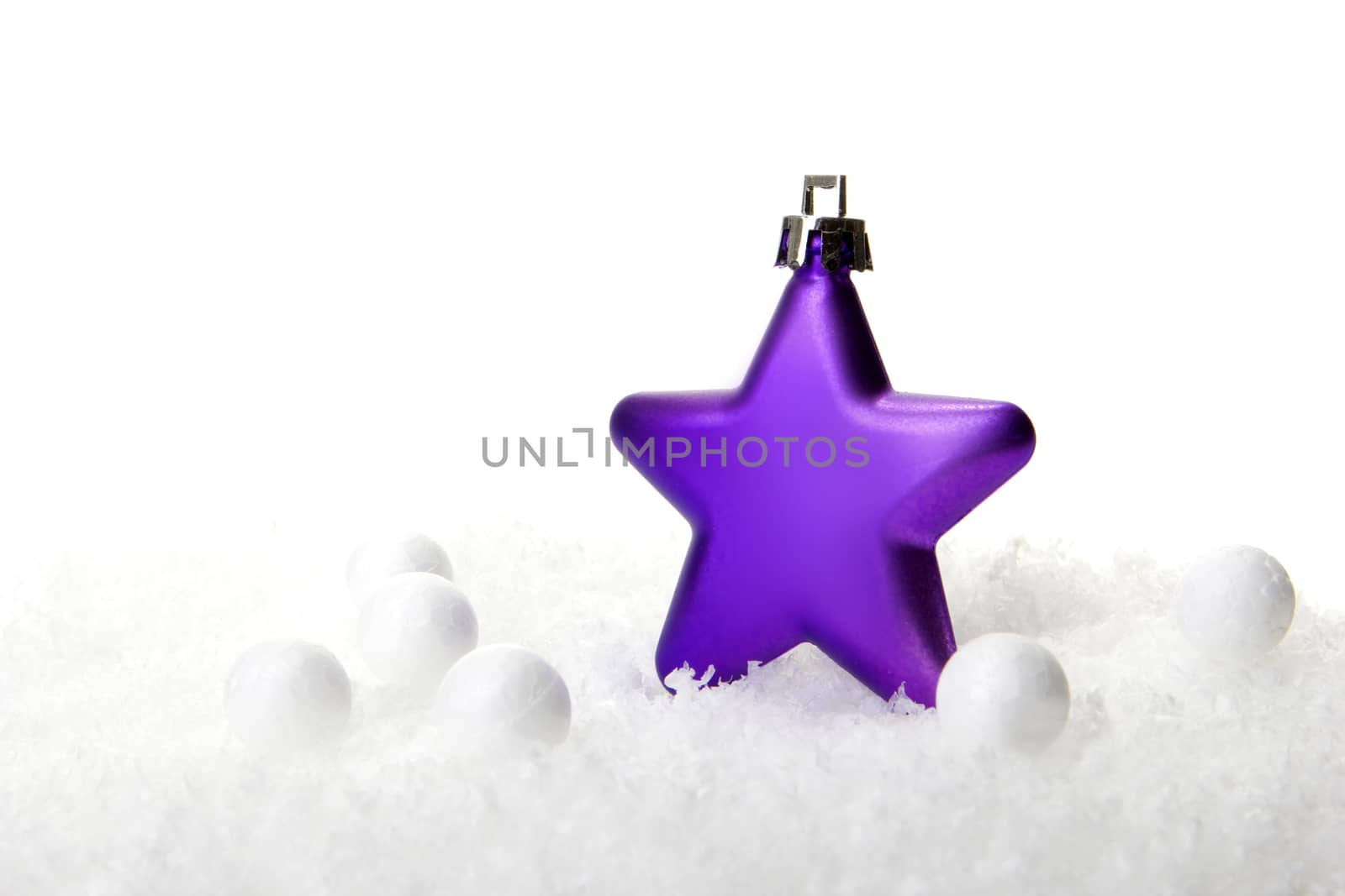 purple christmas bauble as christmas star on snow