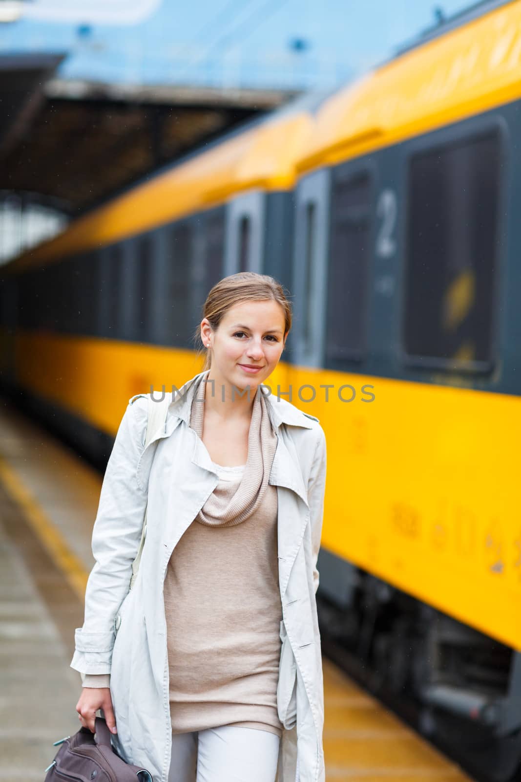 Pretty young woman at a train station (color toned image) by viktor_cap