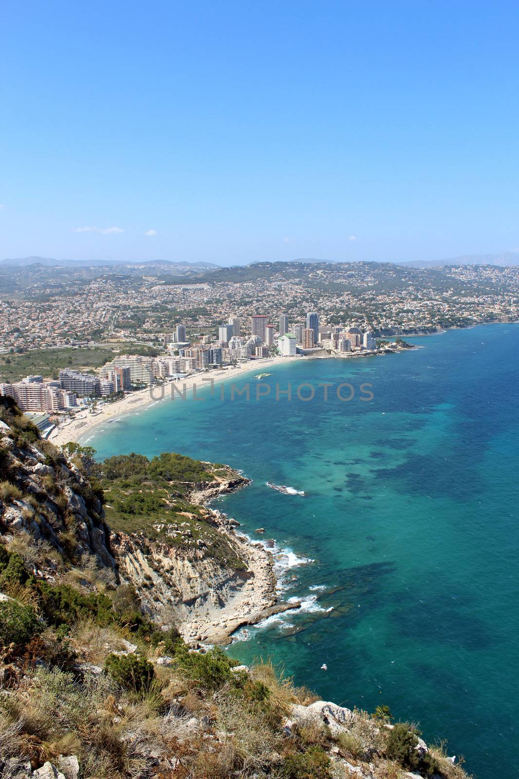 Panoramic view over Calp (Spain). Town bay beach