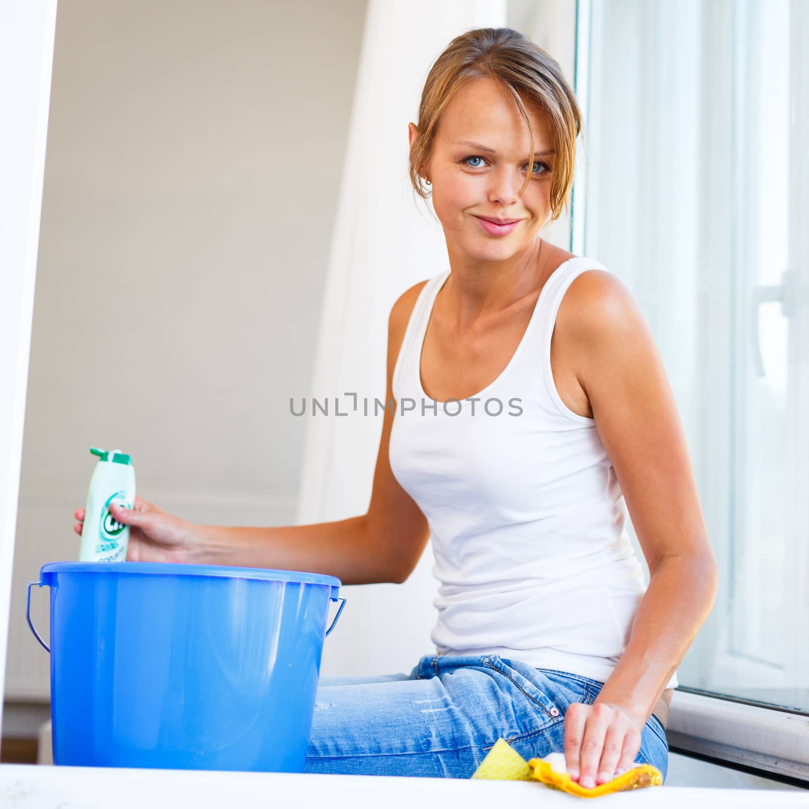 Pretty, young woman doing house work - washing windows (shallow  by viktor_cap