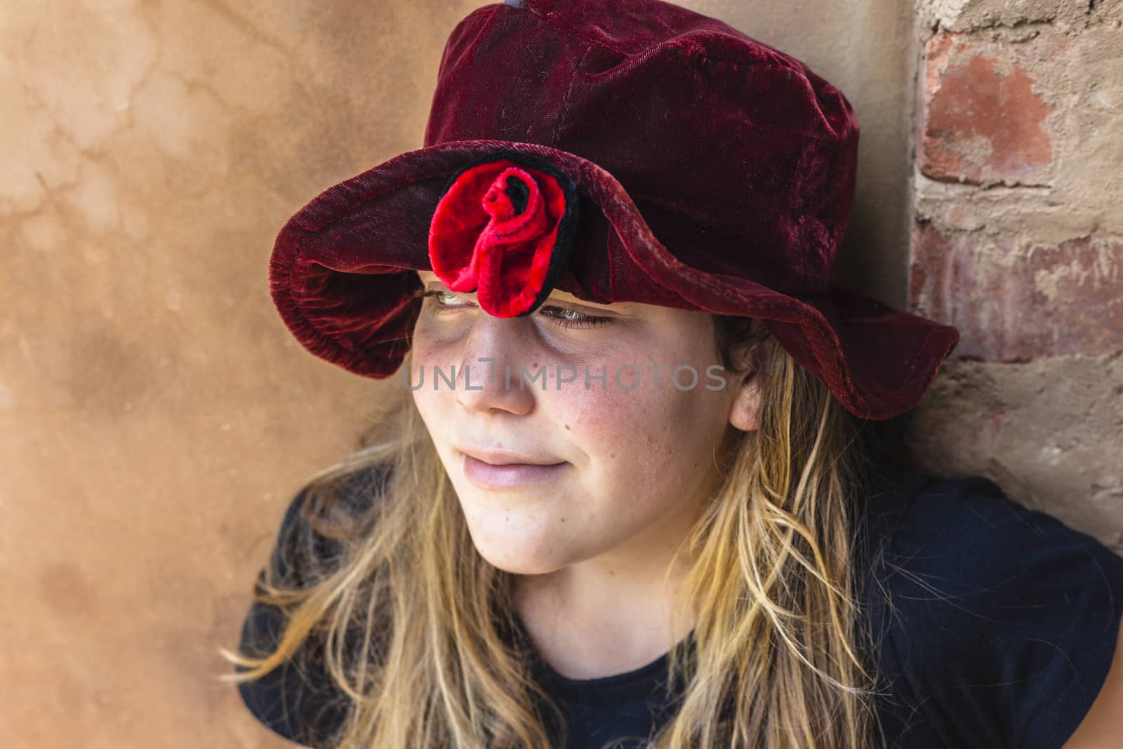 Teen girl wearing red flower material hat