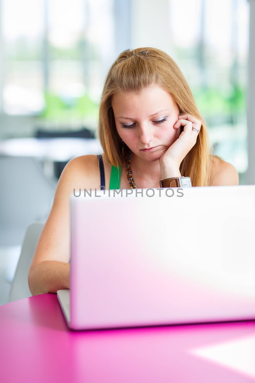 pretty female college student working on her laptop computer by viktor_cap