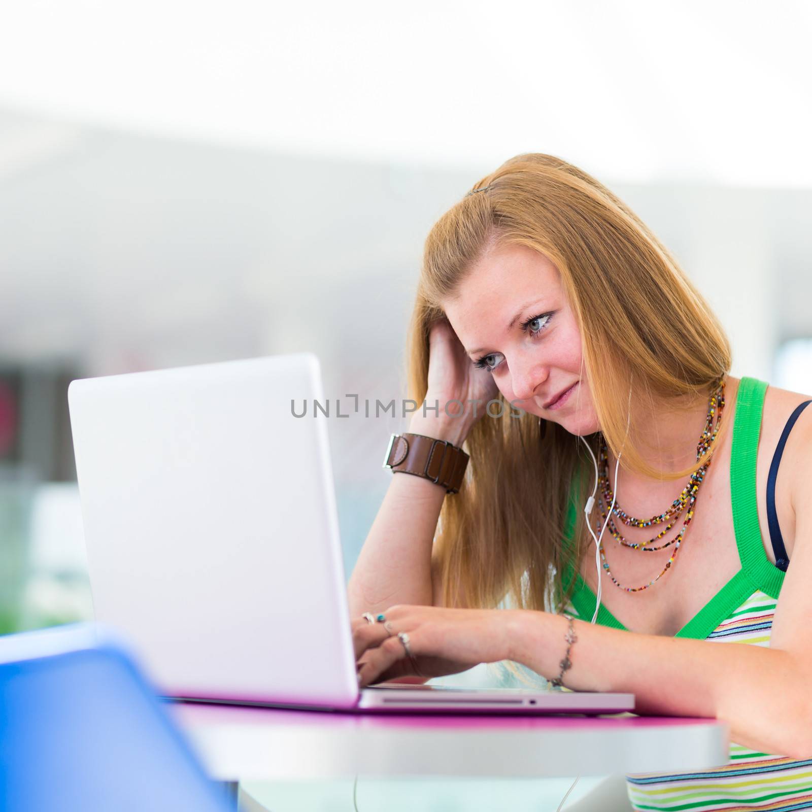 pretty female college student working on her laptop computer by viktor_cap