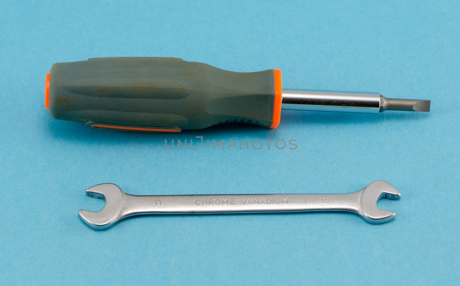 screwdriver turn-screw spanner tommy wrench construction work hand tools on blue background.