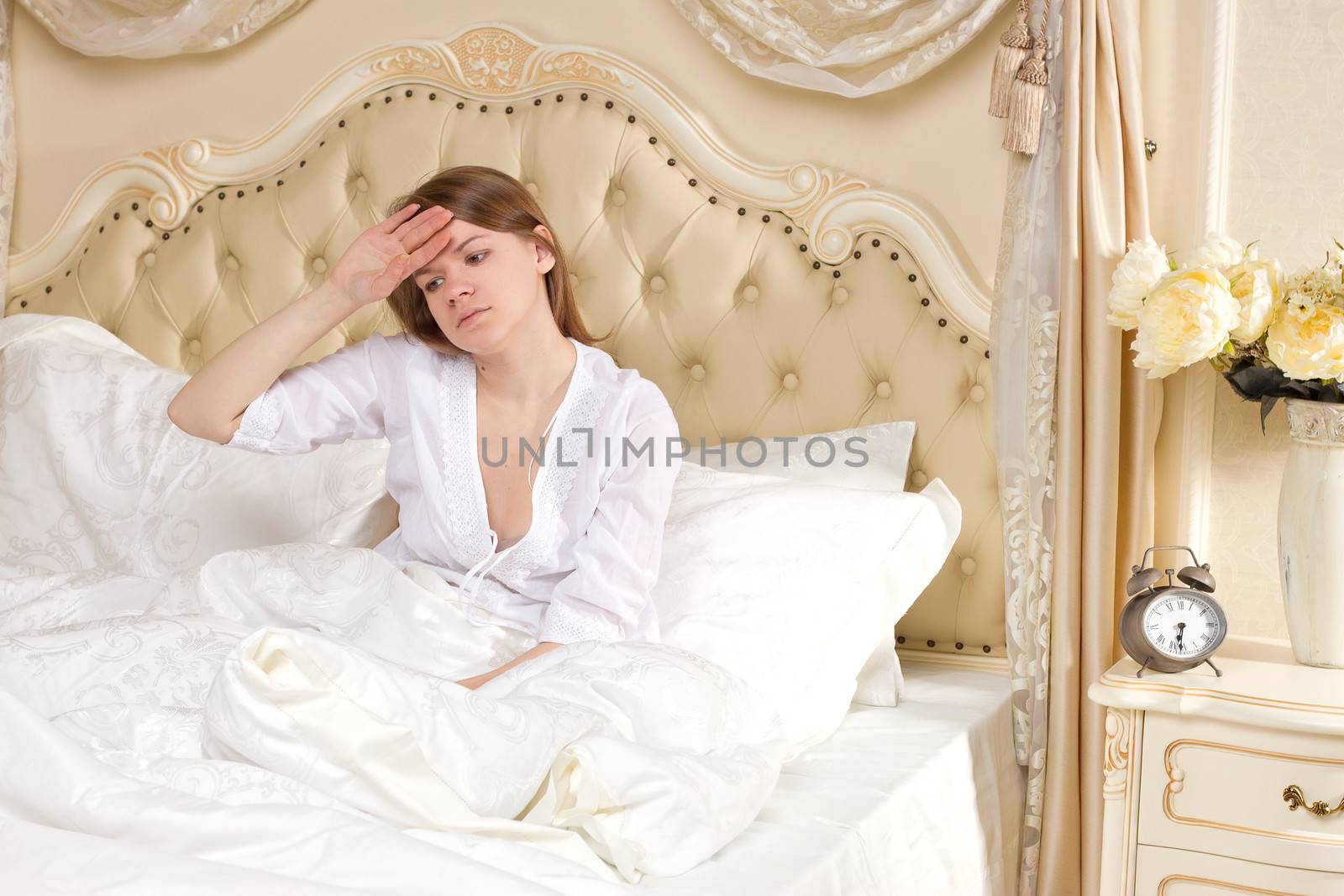 Tired woman sleeping on a bed at home