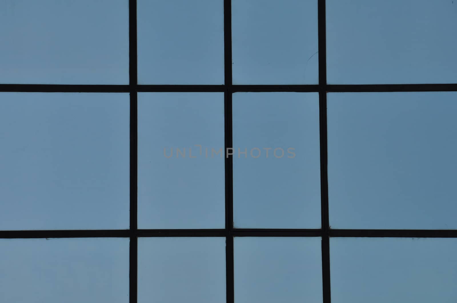 Straignt black lines and blue rectangular windows. Modern facade abstract detail.