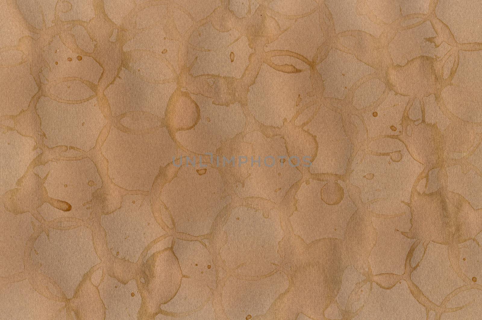 Coffee stains on brown paper background texture. Abstract pattern.