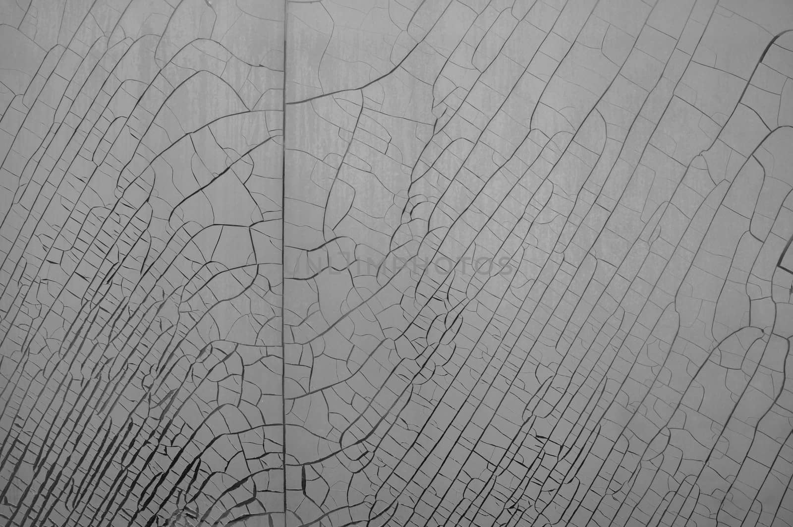 Cracked and weathered plastic window insulation film shrink abstract background.