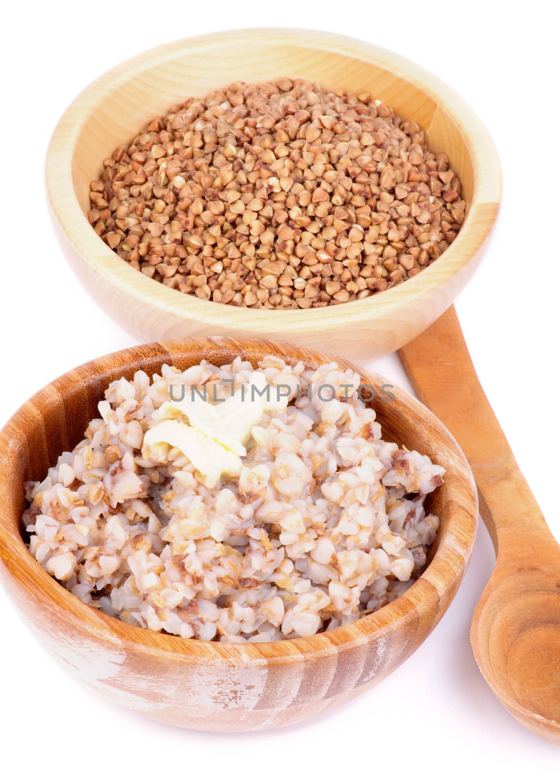 Arrangement of Traditional Russian Buckwheat Kasha with Buckwheat in Wooden Bowl and Wooden Spoon isolated on white background