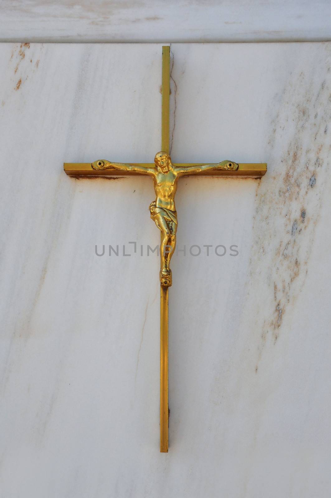Golden crucifix on marble background. Jesus Christ on the cross religious symbol.