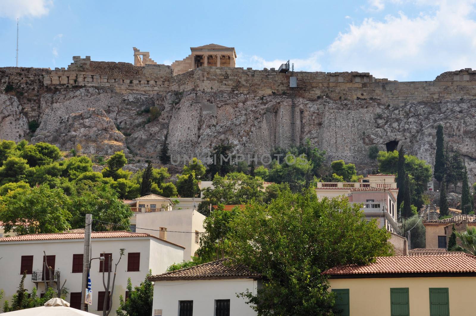 Houses at Plaka neighborhood and the Acropolis walls, Athens, Greece.