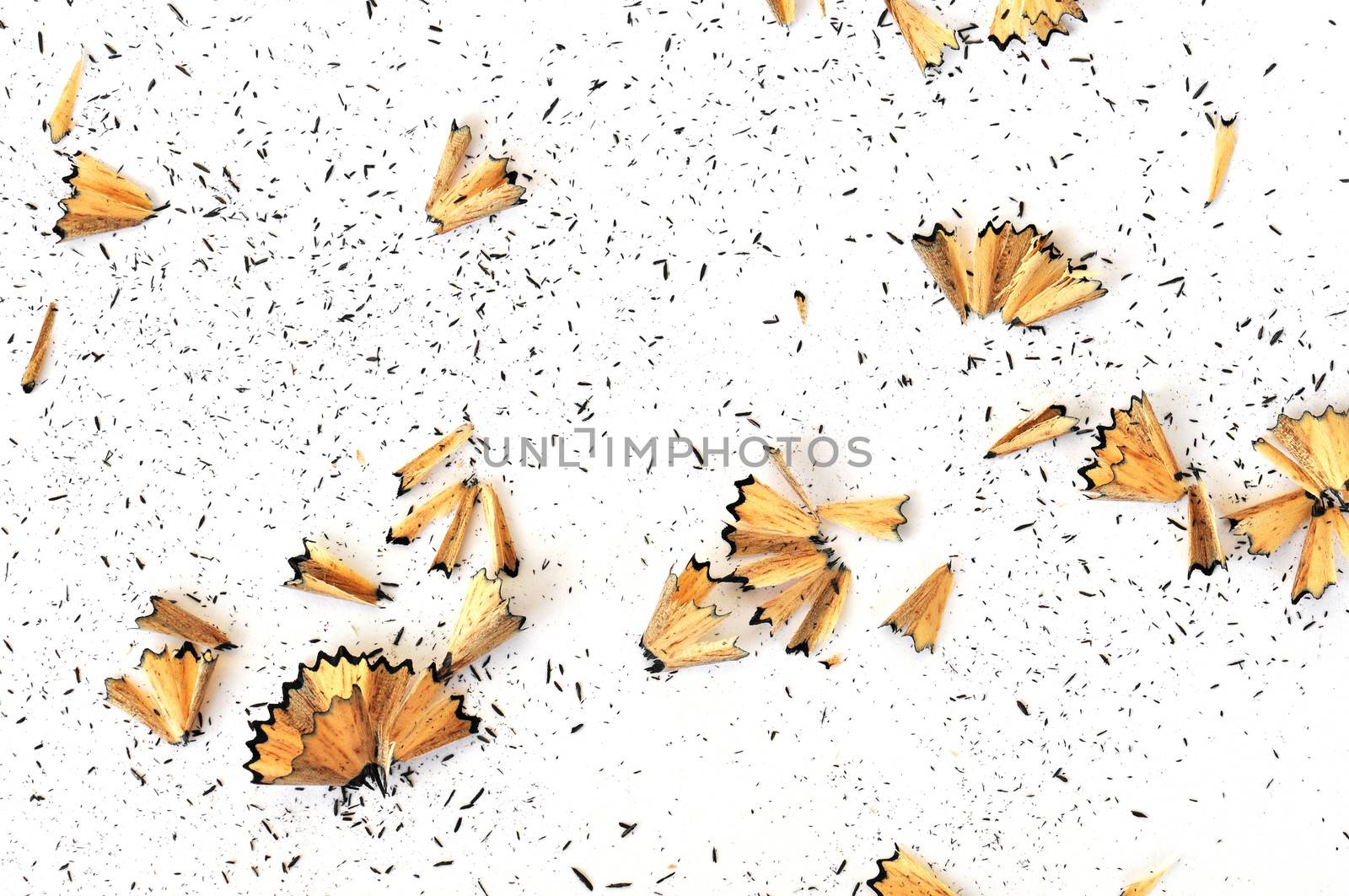 Graphite pencil shavings on white background. Arts abstract.