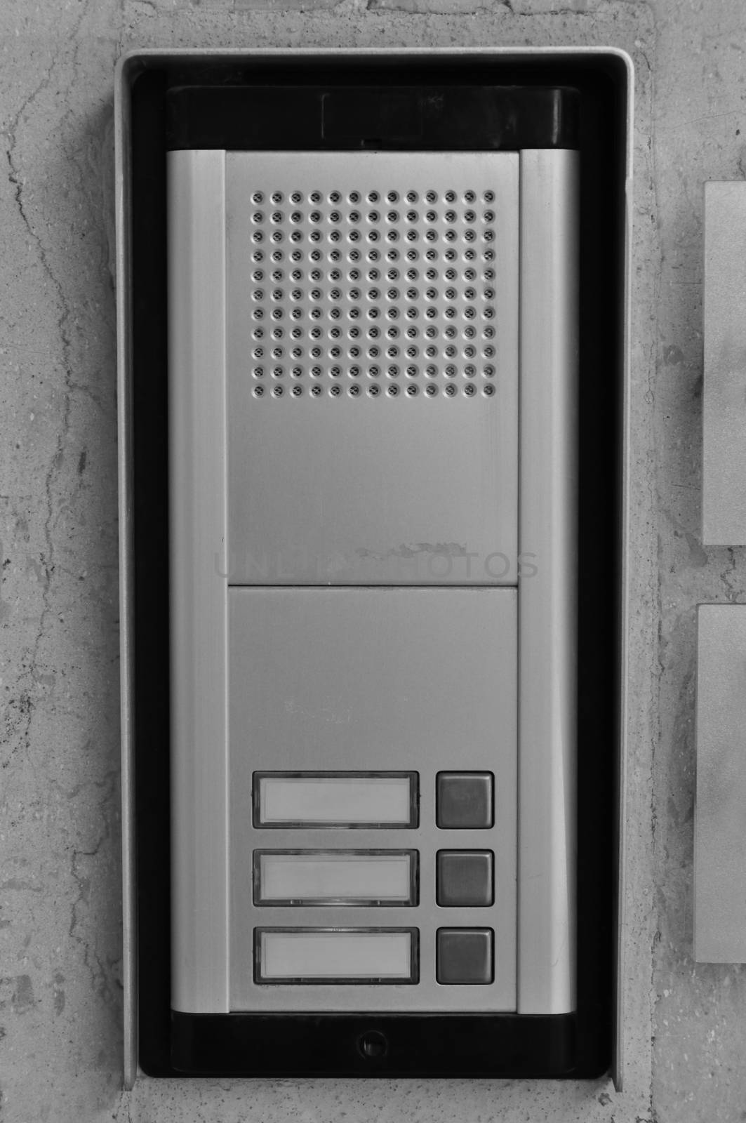 Doorphone intercom doorbell with buttons and speaker. Black and white.