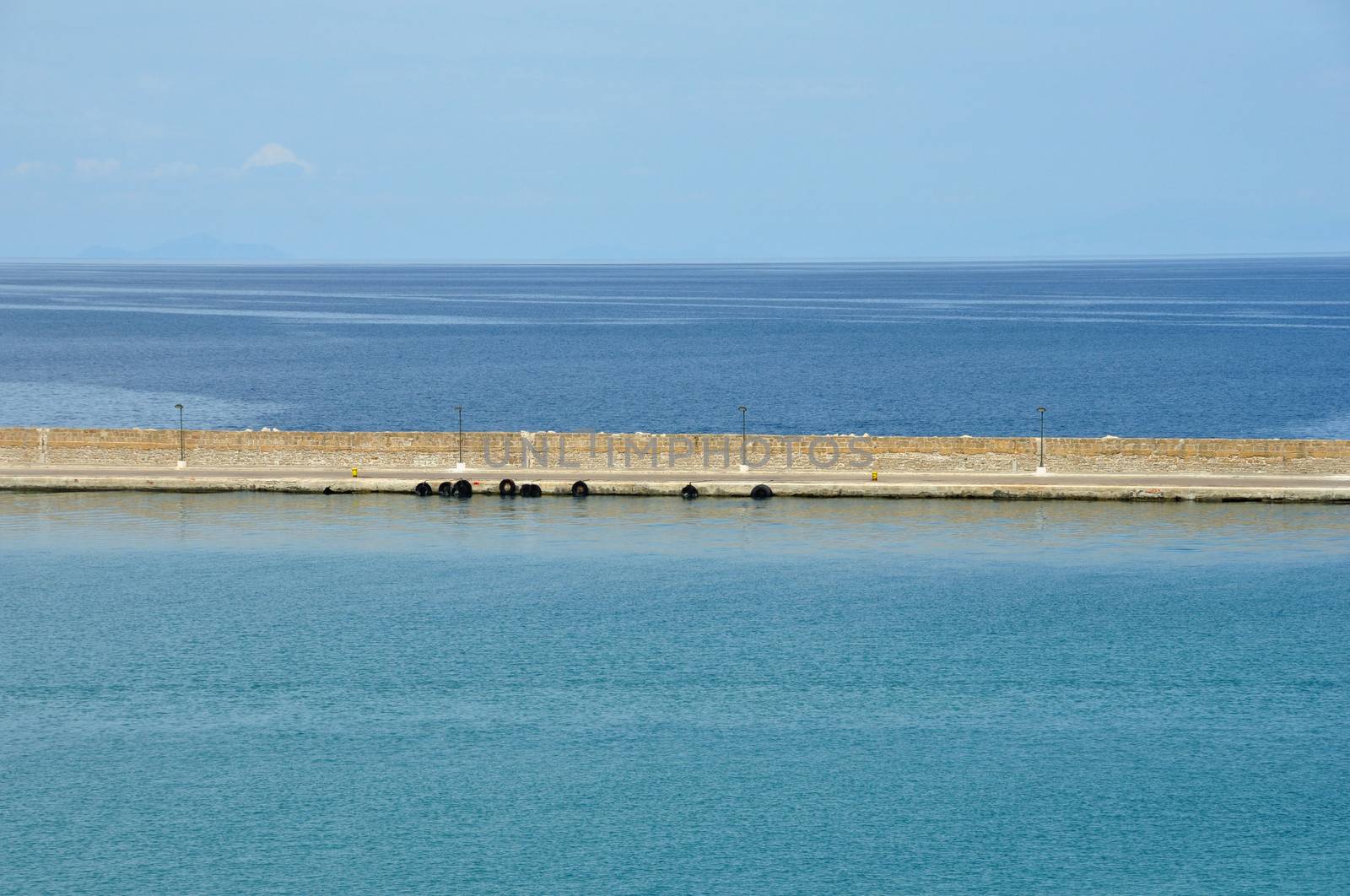 Jetty wall sea and sky horizon abstract background.