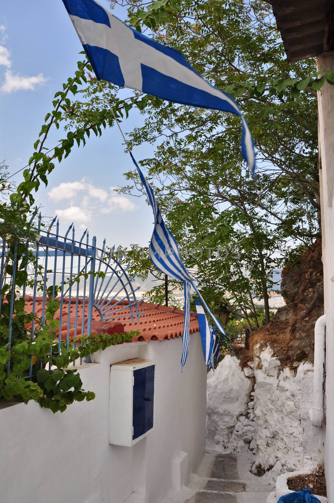 Narrow alleyway and small house in the traditional Anafiotika neighborhood. Cycladic islands style architecture in Plaka, city of Athens, Greece.