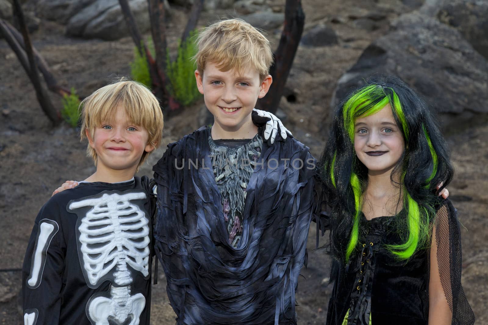 Portrait of three friends in Halloween costume by moodboard
