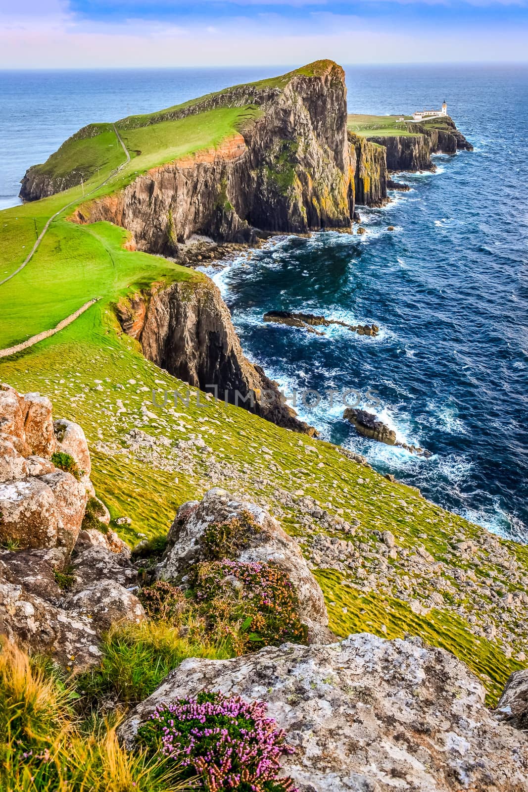 Vertical view of Neist Point lighthouse and rocky ocean coastline, Scotland, United Kingdom