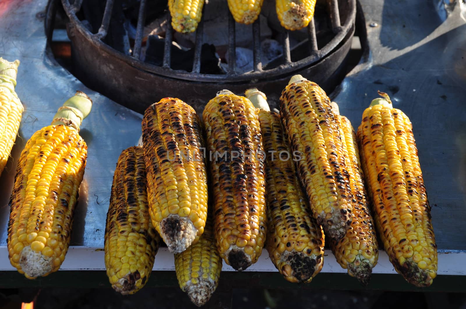 Roasted corn for sale on street market. Food background.