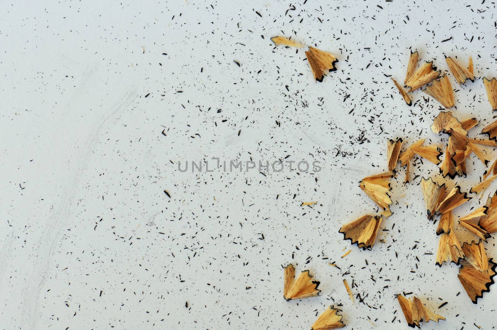 Shavings from sharpened pencil on white background.