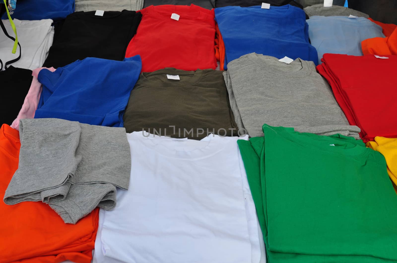 Colorful short sleeve t-shirts background. Casual summer clothes.