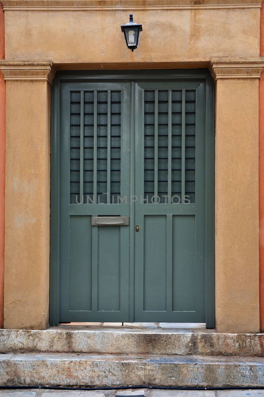 Steps and iron gate neoclassical house exterior. Architectural detail.