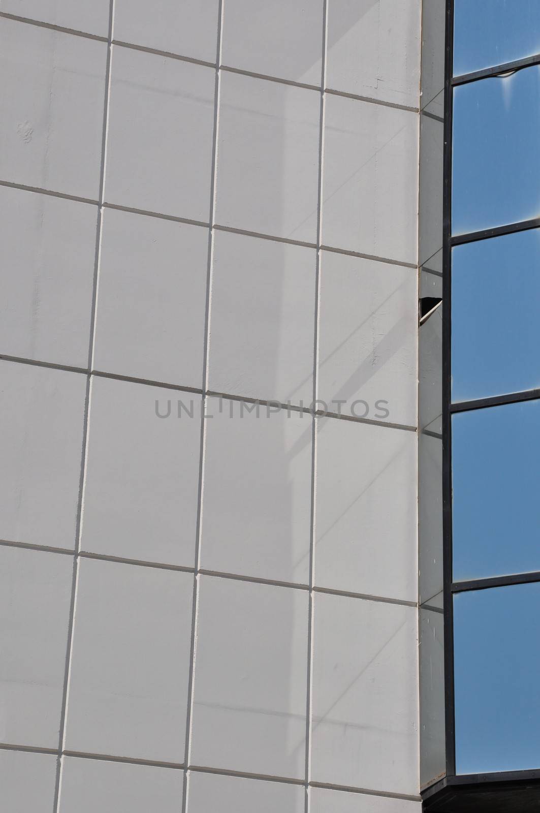 Textured wall and windows modern building abstract architectural detail.