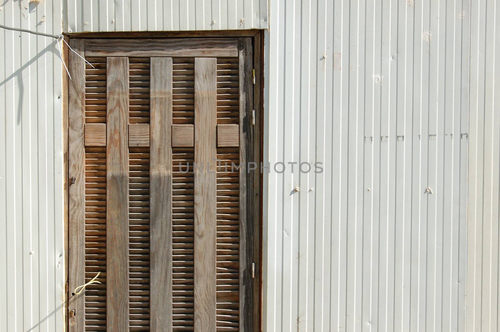 Plastic trailer wall and wooden door exterior abstract background.