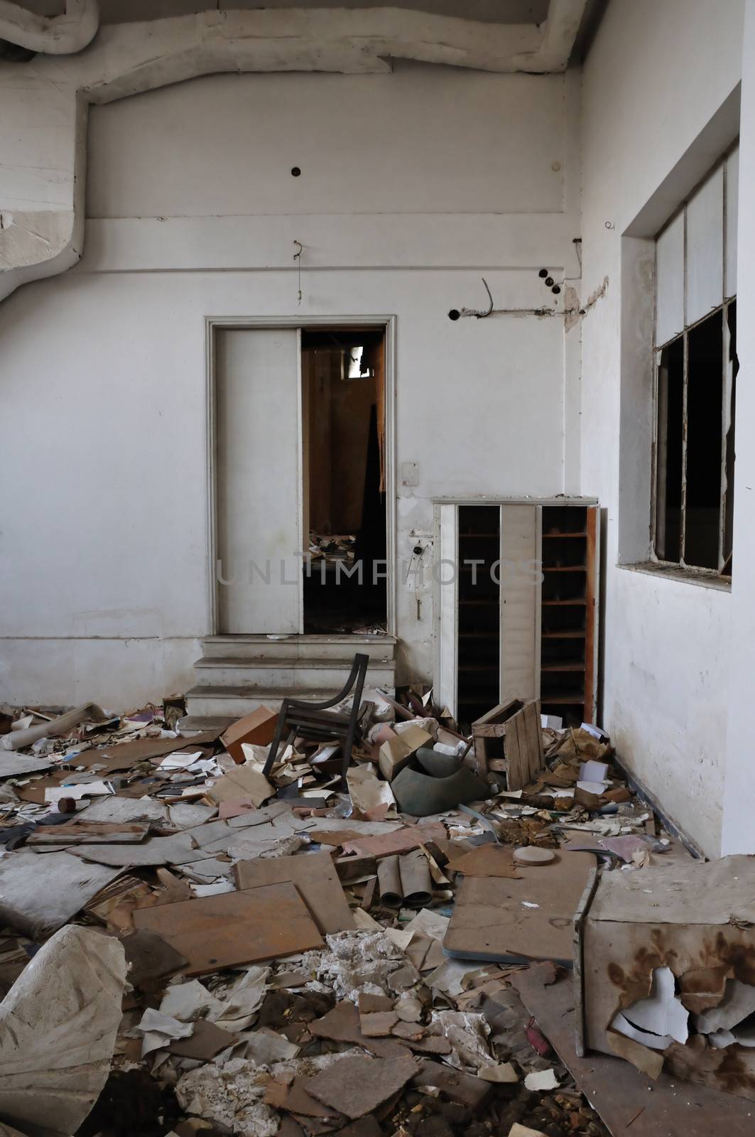 Vandalized room debris on the floor of abandoned building interior.