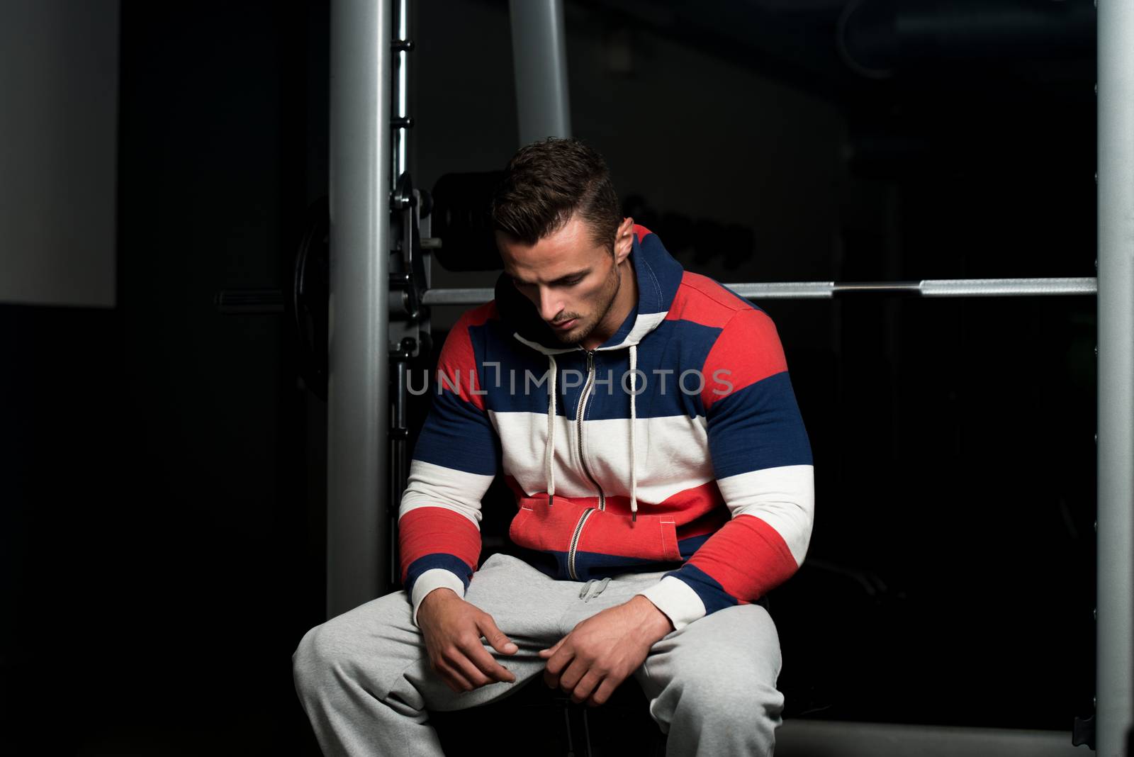 Portrait Of A Young Muscular Sporty Fit Caucasian Man Resting At The Bench