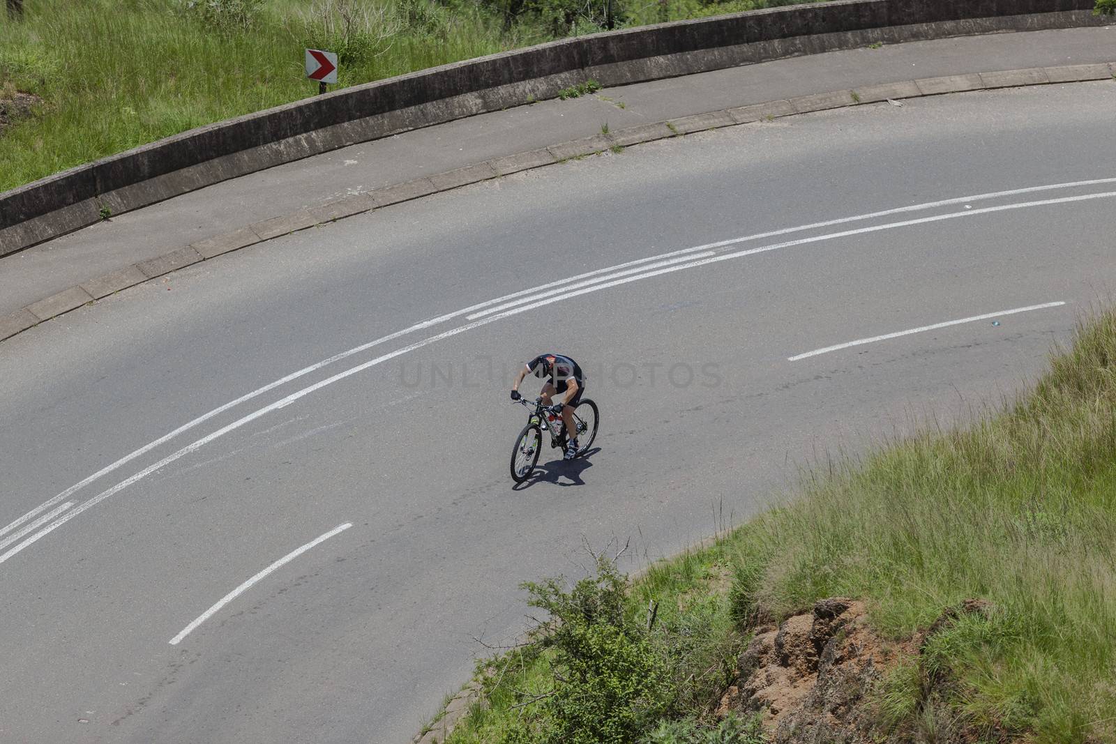 Cyclist Training Uphill Valley by ChrisVanLennepPhoto