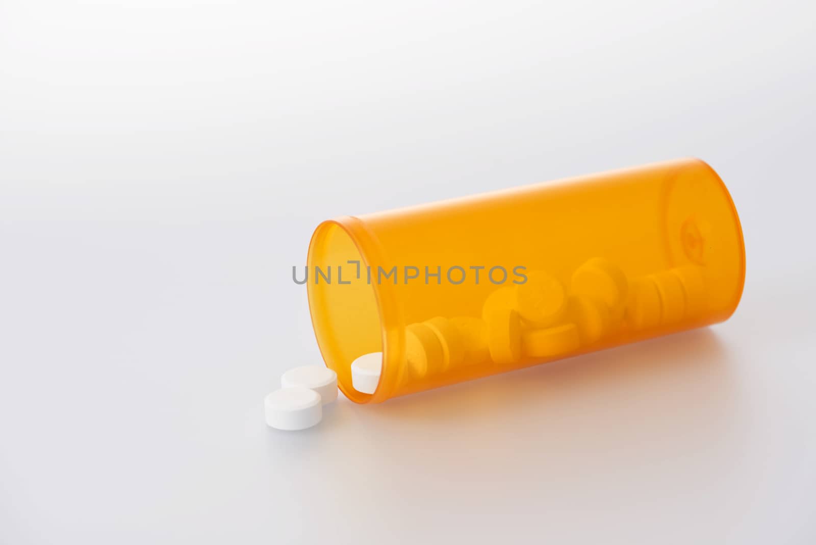 Prescription pills spilling out of bottle