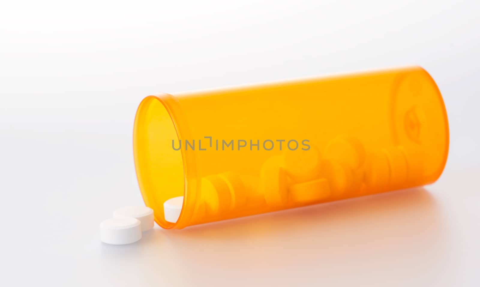 Prescription pills spilling out of bottle