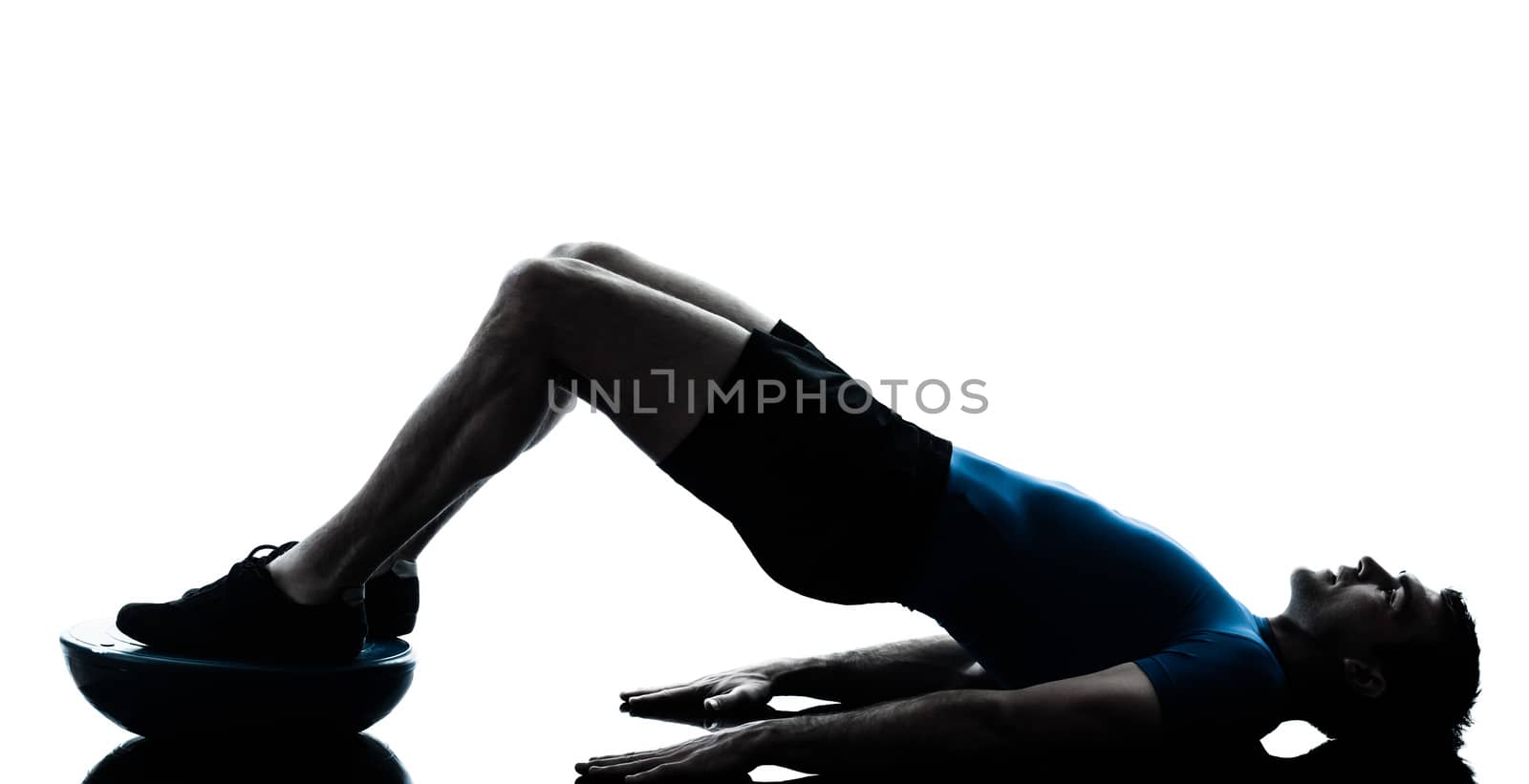 one caucasian man exercising bosu workout fitness in silhouette studio isolated on white background