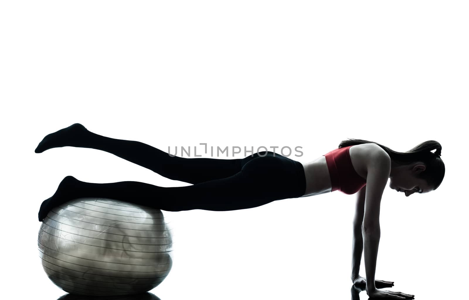 one caucasian woman exercising fitness ball in silhouette studio isolated on white background