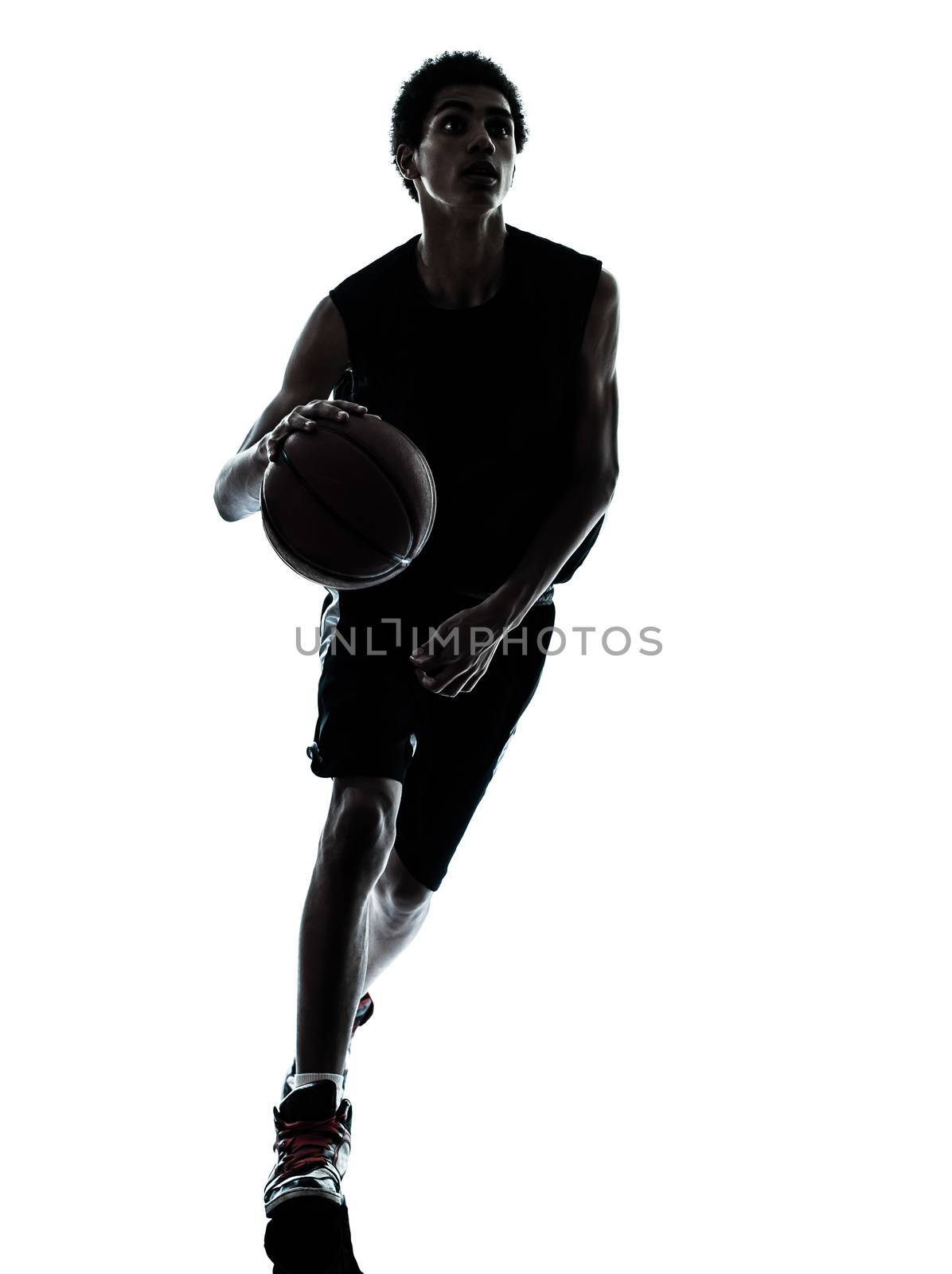 one young man basketball player dribbling silhouette in studio isolated on white background