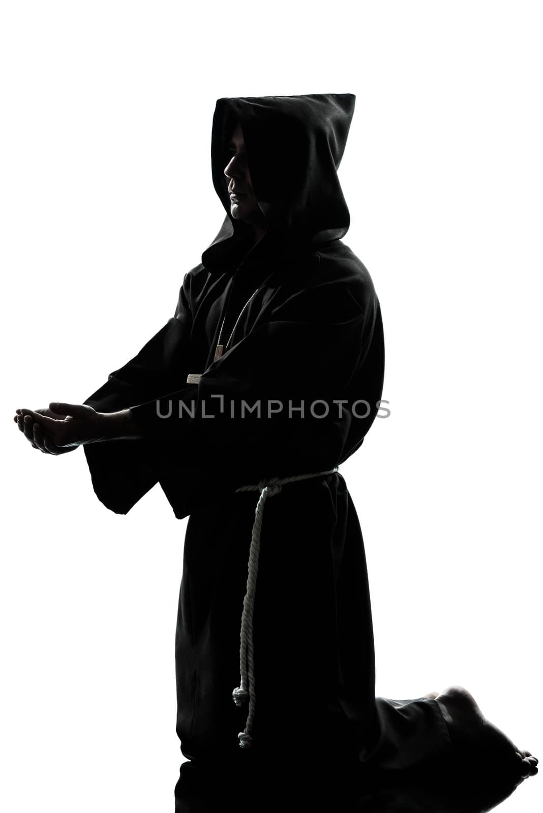 one caucasian man priest praying silhouette in studio isolated on white background