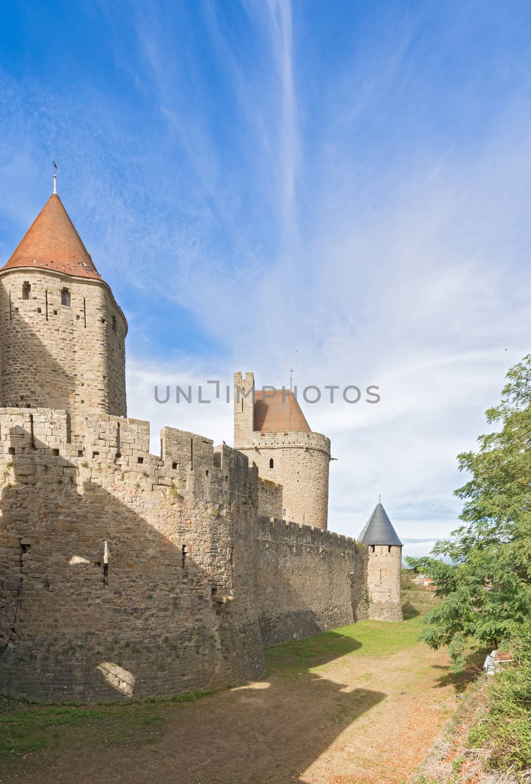 Carcassonne, France - November 2, 2013: View of the medieval walled city of Carcassonne and its castle on a sunny day.