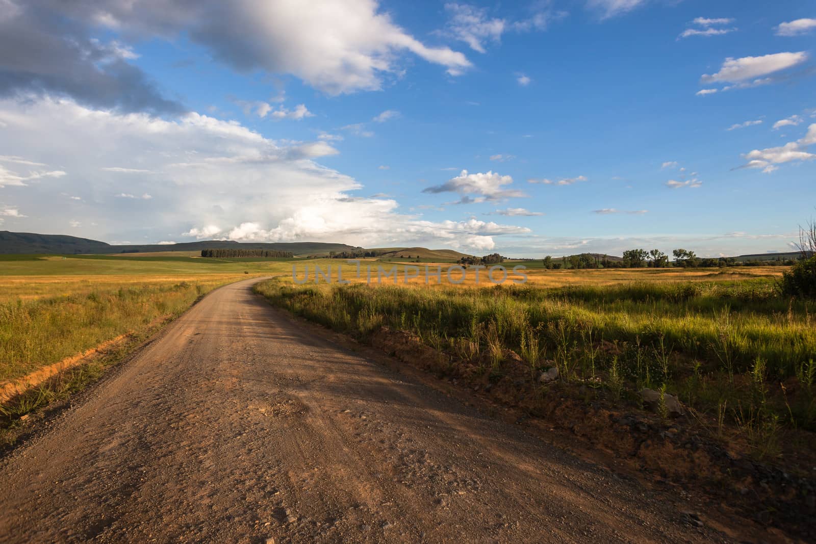 Driving on mountain dirt road late afternoon with colors through the countryside