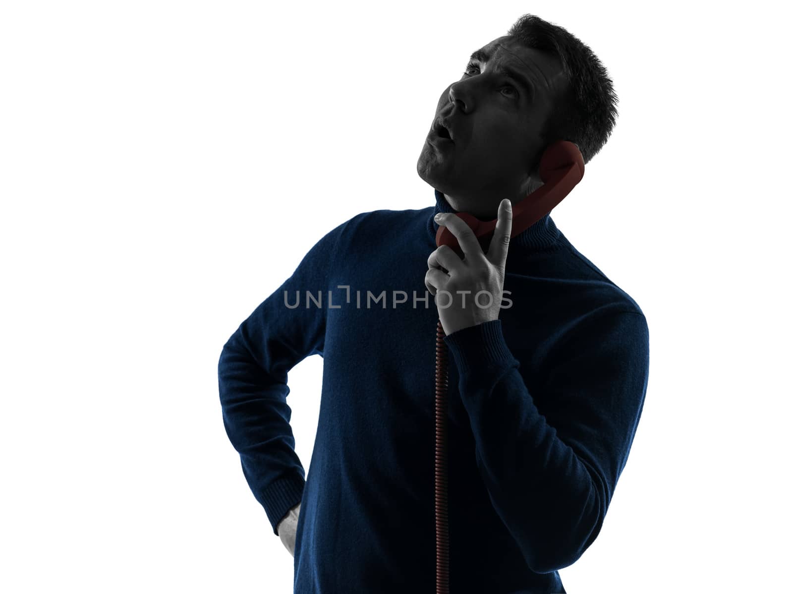 one caucasian man surprised on the phone portrait in silhouette studio isolated on white background