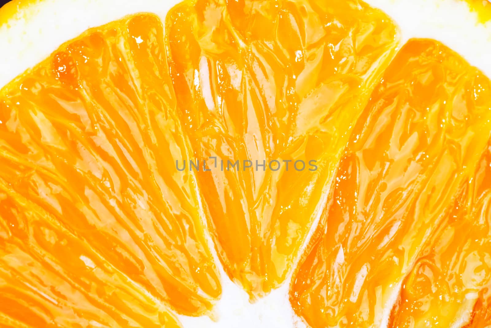 Slice of fresh orange fruit closeup macro by RawGroup