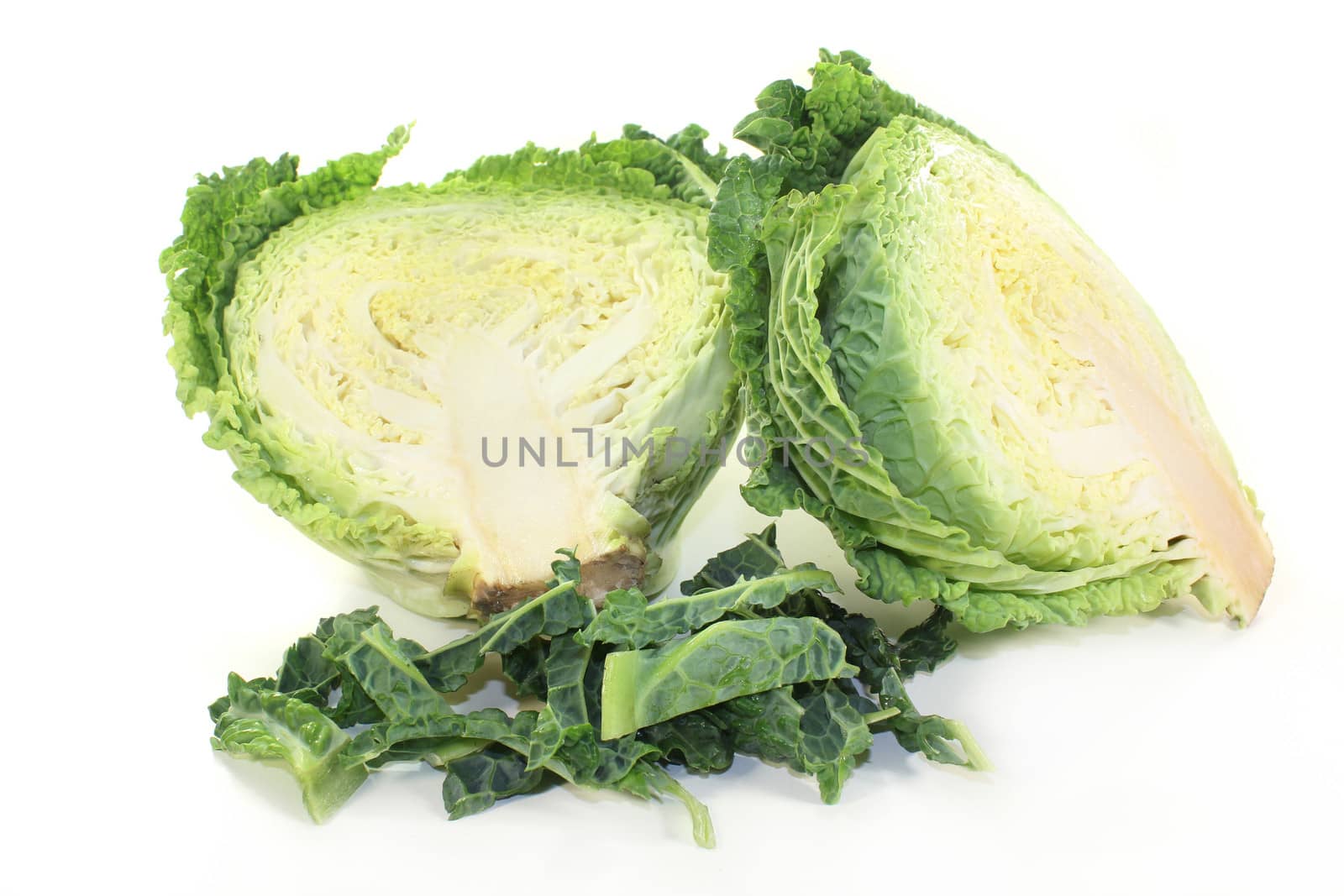 a sliced savoy cabbage against white background