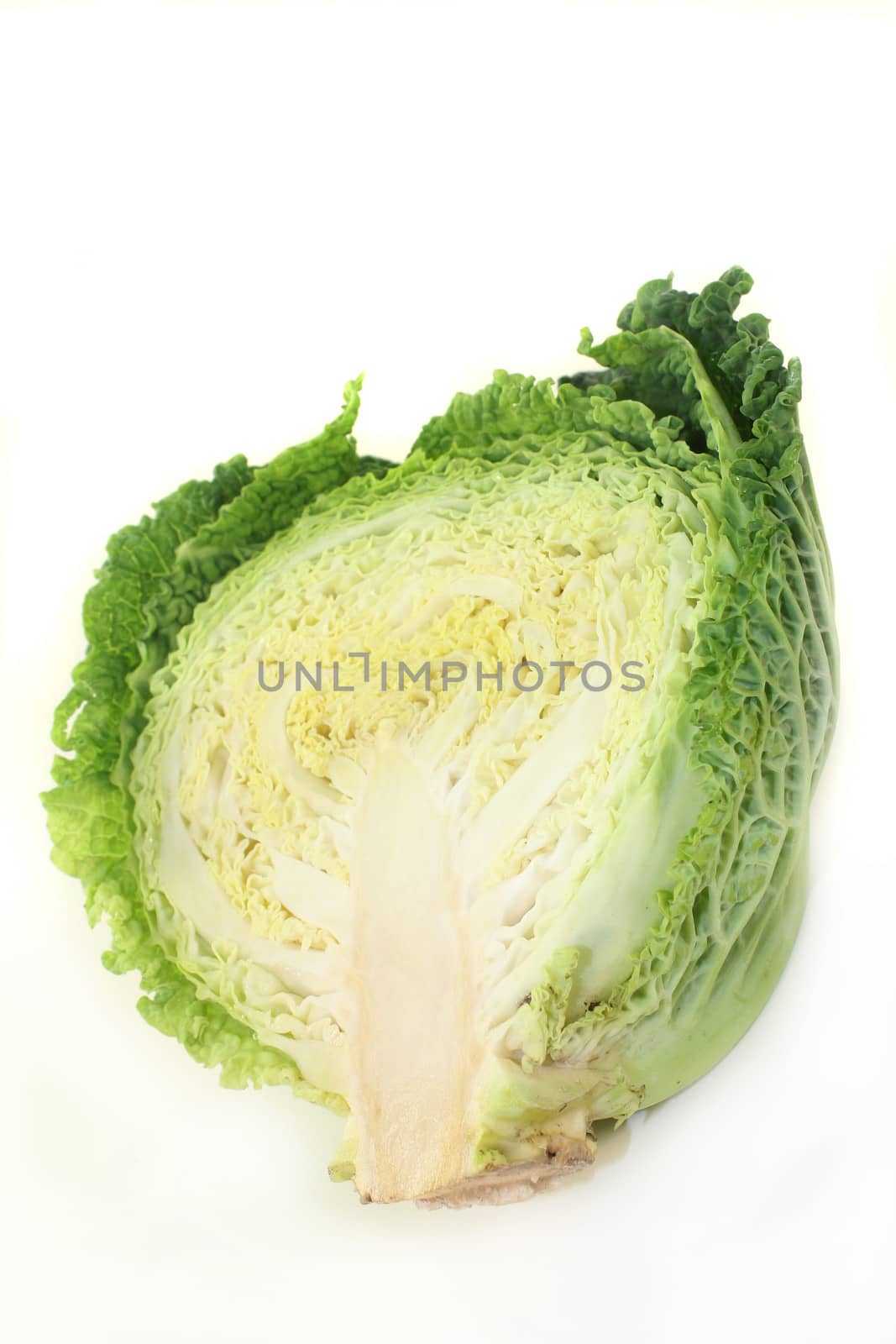 a sliced savoy cabbage against white background