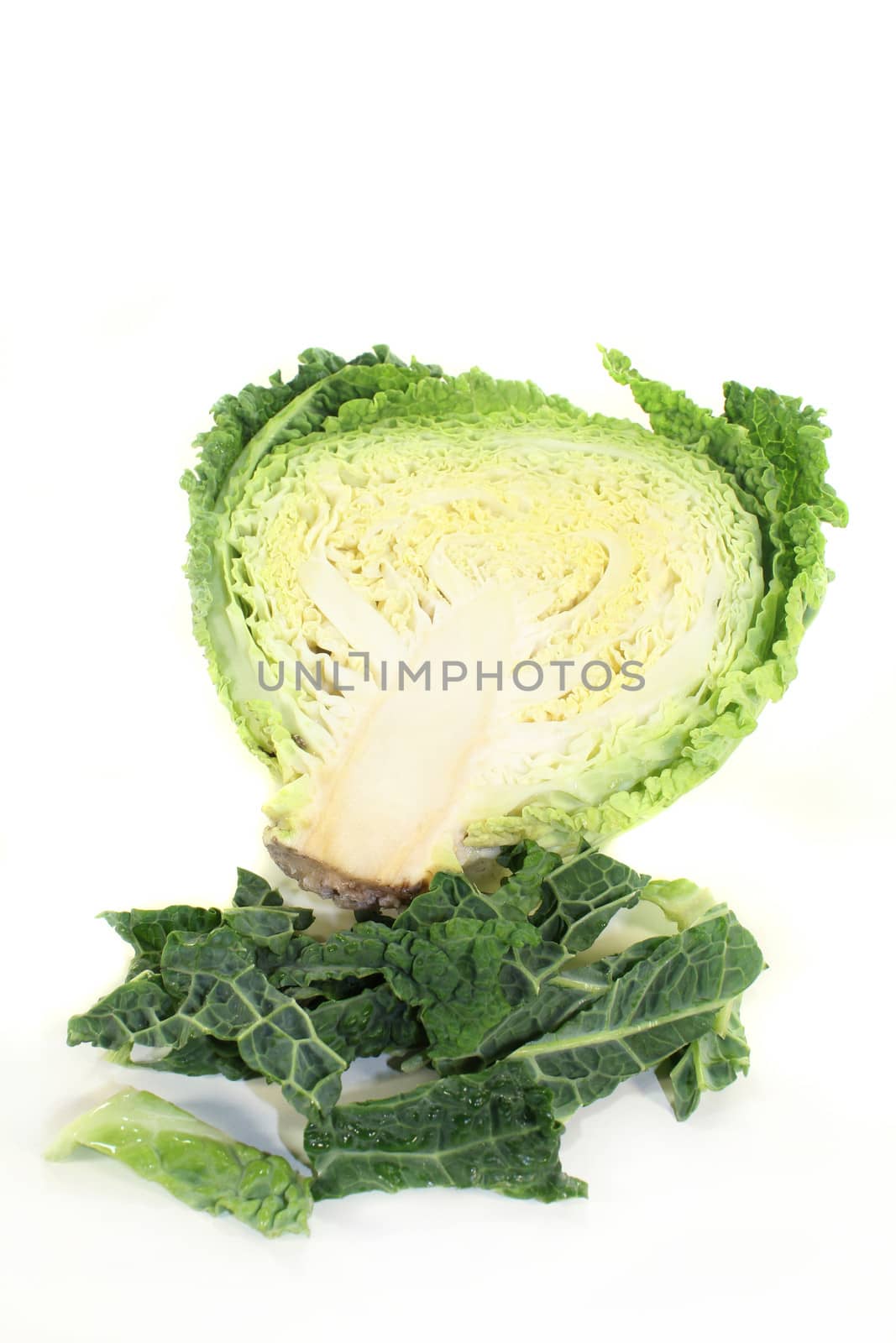 a sliced savoy cabbage against white background